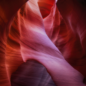 Sun shines into the slot canyon walls of Antelope Canyon in northern Arizona