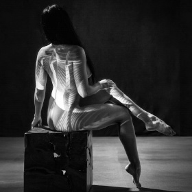 Fine art nude with projection lighting.