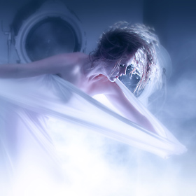 Tranlucent spandex material reveals the form and figure of model Julianna as the backlighting blasts through the fog.