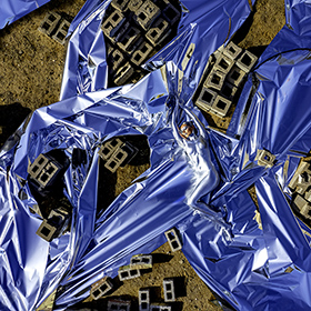 Carrie Esser in silver bodypaint at the Junkyard