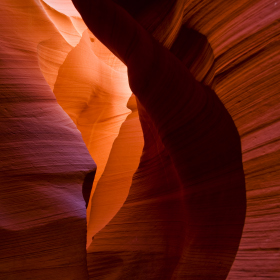 Sun shines into the slot canyon walls of Antelope Canyon in northern Arizona
